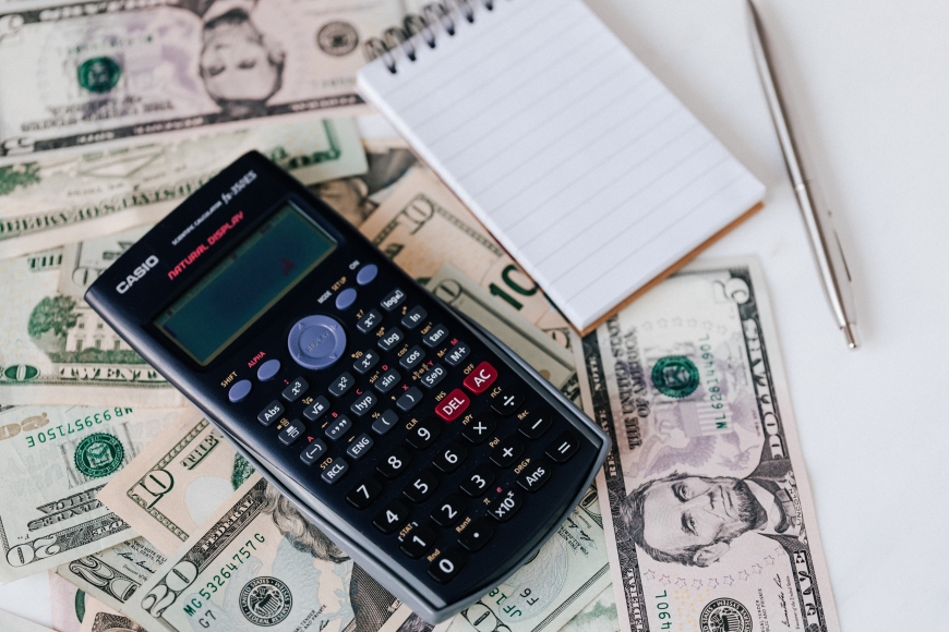 calculator on dollar bills