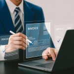 professional-managing-online-invoices-with-laptop